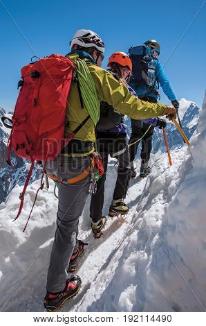 Close-up of climber in french Alps Chamonix Mont Blanc, alpine mountains landscape, clear blue sky in warm sunny summer day