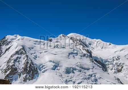 View of the Mont Blanc from the Aiguille du Midi, in French Alps Chamonix Mont Blanc, alpine mountains landscape, clear blue sky in warm sunny summer day