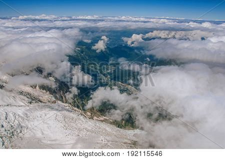 View of peaks, glacier and Chamonix Valley from the Aiguille du Midi, in French Alps Chamonix Mont Blanc, alpine mountains landscape, blue sky in sunny summer day