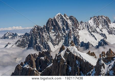 Close up of snowy peaks, view from the Aiguille du Midi, in French Alps Chamonix Mont Blanc, alpine mountains landscape, clear blue sky in warm sunny summer day