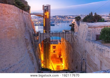 Upper Barrakka Lift, from Grand Harbour to Upper Barrakka Gardens, during morning blue hour, Valletta, Malta