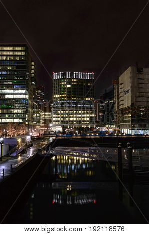 Boston Massachusetts USA - January 26 2017: Lights along Harborwalk reflecting off water on Boston waterfront