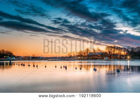 Helsinki, Finland. Landscape With City Pier, Jetty At Winter Sunrise Or Sunset Time.  Tranquil Sea Water Surface At Early Morning Near Havsparken Meripuisto.