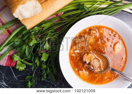 Vegetables And Meat In Red Beetroot Soup Or Borsch In White Plate With Metal Spoon In It On Dark Mar