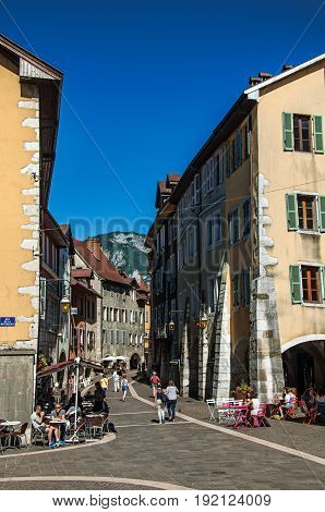 Annecy, France - June 28, 2016. Colorful street with old buildings and people in the city center of the historic Annecy, department of Haute-Savoie, Auvergne-Rhône-Alpes region, south-eastern France