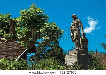 Talloires, France - June 29, 2016. Statue with trees in the lovely village of Talloires, near the Lake of Annecy. Department of Haute-Savoie, Auvergne-Rhône-Alpes region, south-eastern France