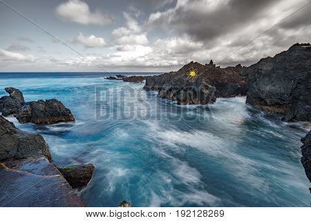 Wide angle long exposure of Biscoitos with volcanic rocks in Terceira Island, Portugal