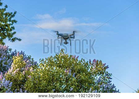 Drone quad copter with digital camera on the sky.