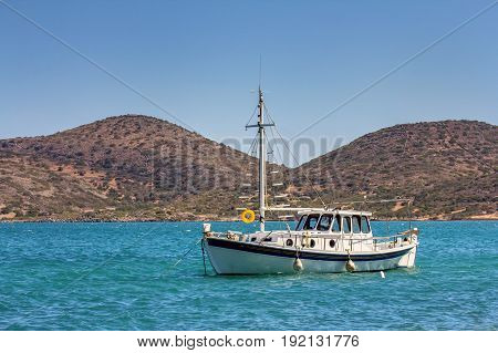 A moored small boat in the Gulf of Mirabello near the village of Elounda. Crete. Greece