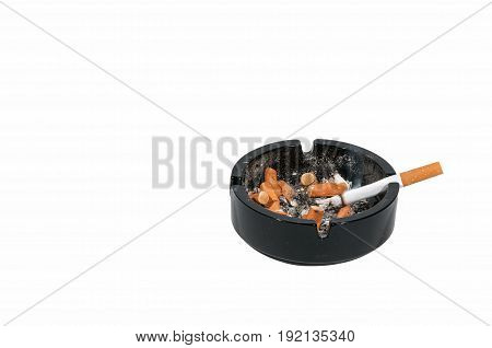Ashtray. Dirty black ceramic ashtray with a cigarette, full of smokes cigarettes. Isolated on a white background.