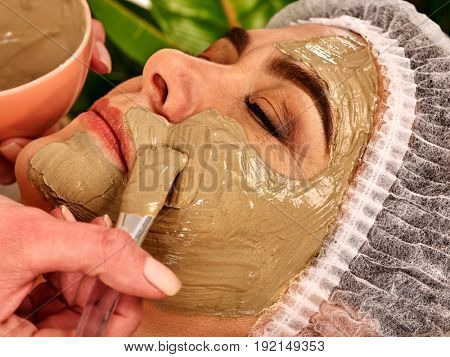 Collagen face mask. Facial skin treatment. Elderly woman 50-60 years old receiving cosmetic procedure in beauty salon. Professional beautician removing wrinkles. Therapeutic mud for home masks.