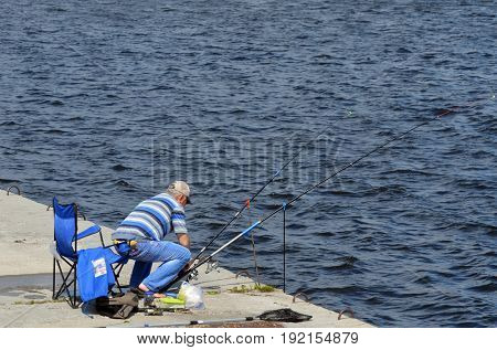An unidentified person fishing.Modern residential area Obolon.June 21 ,2017 in Kiev, Ukraine