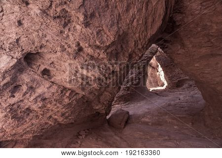 Rock Cave in the Mountains with triangular opening