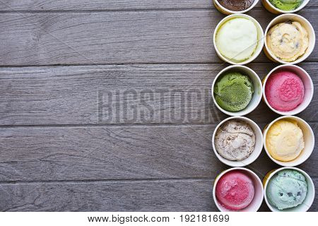 Top view Ice cream flavors in cup on wood table