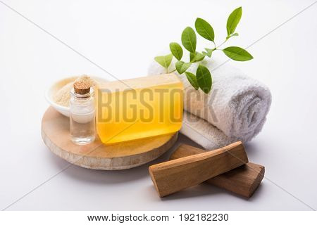 Ayurvedic handmade  Sandalwood both soap or chandan sabun with sandalwood sticks, ubtan or scrub or powder, oil and white towel, selective focus