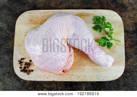 Fresh raw chicken legs arrangement on kitchen cutting board