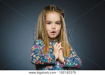 Closeup Portrait of little girl going surprise on gray background.