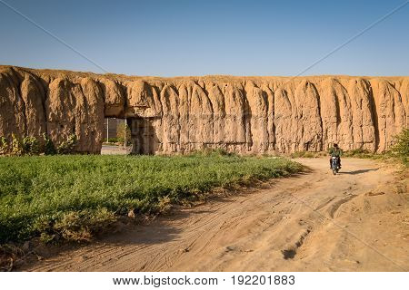 KASHAN IRAN - OCTOBER 21 2016 : Gate of old city walls and green plantation area in Kashan Isfahan province Iran.