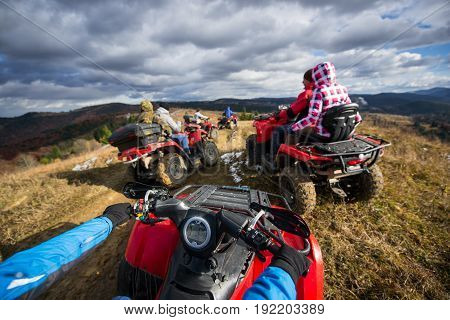 View From Atv A Group Of People Riding A Quad Bikes On A Mountain Road Under A Sky With Clouds In Au