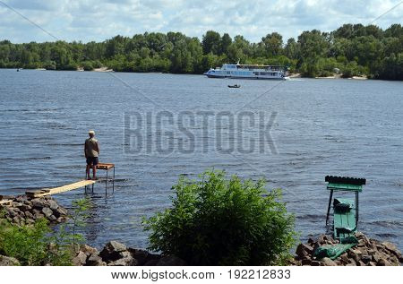An unidentified person fishing.Modern residential area Obolon.June 21 ,2017 in Kiev, Ukraine