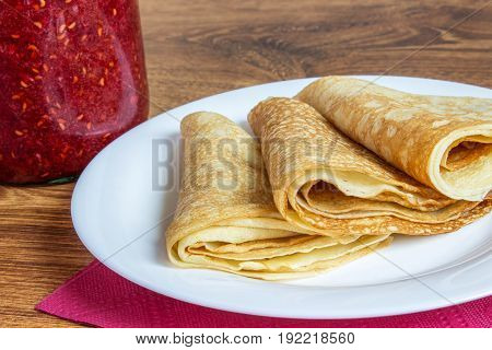 Fresh Homemade Folded Crepe Filled With Strawberry Jam On Plate