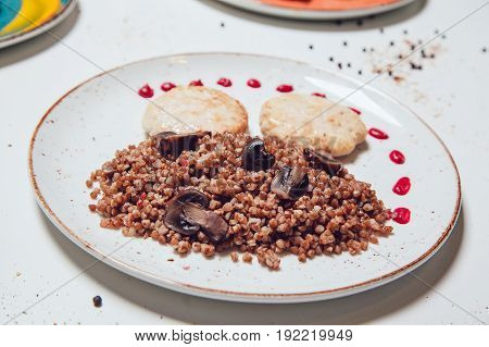 Chicken cutlets with greek croutons and mushrooms for garnish.