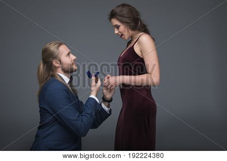 Young Man In Tuxedo Making Marriage Proposal To His Girlfriend