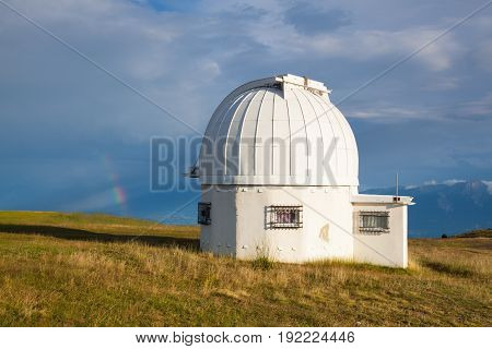 Rainbow and observatory dome in the Gerlitzen Apls in Austria.View of the mountains in Slovenia.