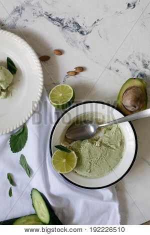 Beautiful composition with hand made tasty ice cream prepared with avocado and lime