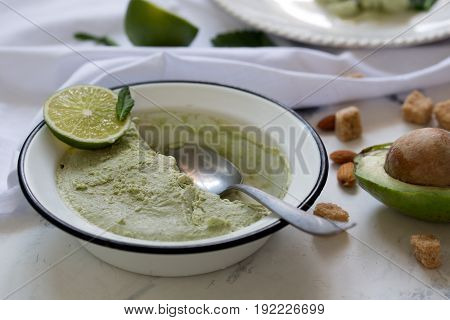 Beautiful composition with hand made tasty ice cream prepared with avocado and lime