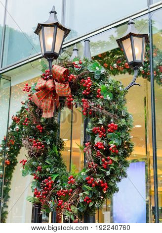 Christmas wreath hanging on a street lamp