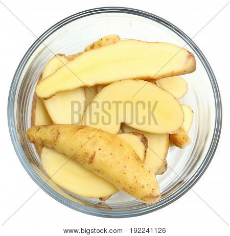 Fingerling Potatoes sliced in bowl over white.