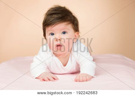 Bright blue eyed beauity 6 month old baby girl.