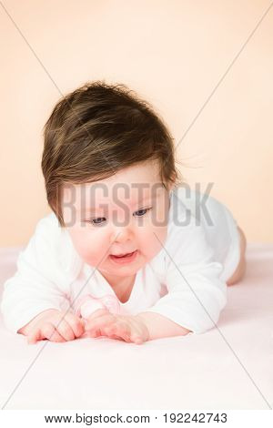 Bright blue eyed beauity 6 month old baby girl.