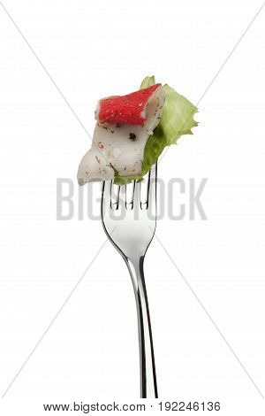 Shiny metal fork with surimi and iceberg lettuce isolated on white background