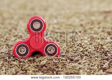 Top view of the popular red spinner on a green artificial lawn