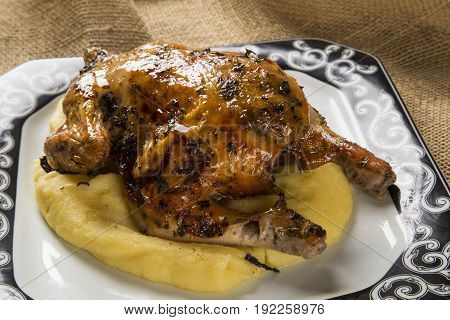 Little Chicken Dish With Polenta On Wood Background