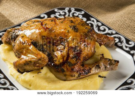 Little Chicken Dish With Polenta On Wood Background