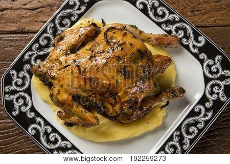 Little Chicken Dish With Polenta On Wood Background
