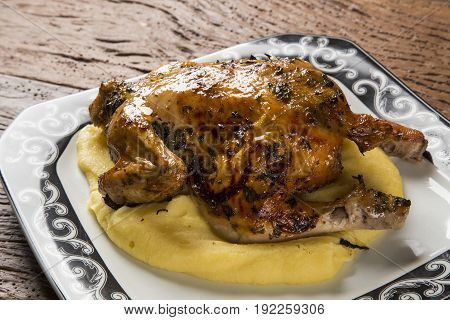 Little Chicken Dish With Polenta On Wood Background