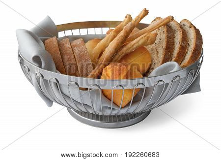 Slices of bread, bread sticks and corn bread (proja) in basket on a white background