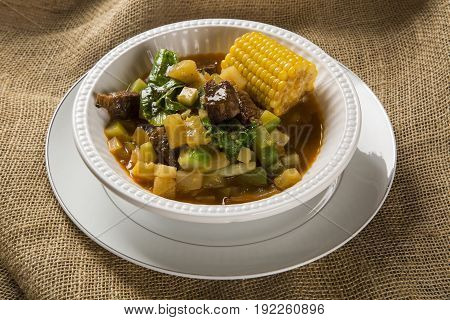 South American Cuisine: Puchero Soup With Chickpeas Close-up In A Pot On The Table.