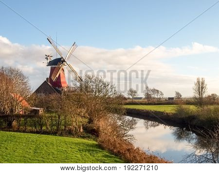Greetsiel, Germany - December 6, 2014: Traditional Windmill working and still used to grind. The second mill is currently under renovation due to a violent hurricane.