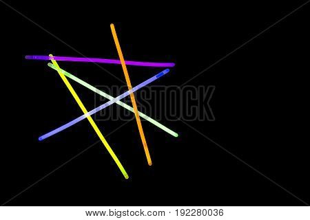 Glow sticks neon light fluorescent on back background. variation of different colored chem lights