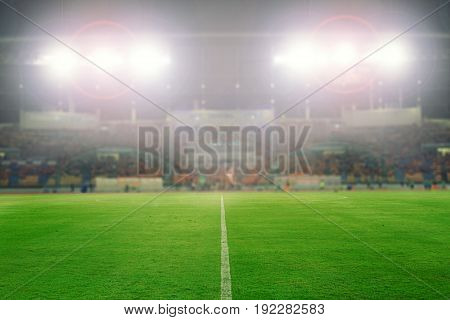 Blurry of football and soccer stadium for background soft focus