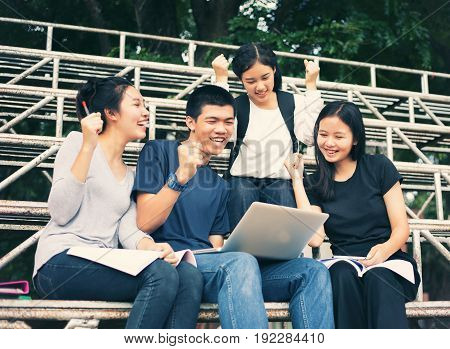 Asian Group of students Success and winning concept - happy team with raised up hands celebrating the breakthrough