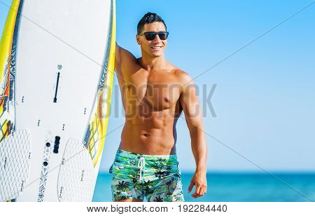 Young surfer handsome young adult man face sport background
