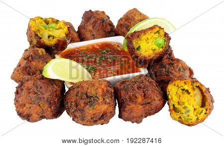Group of fried vegetable pakora with chilli sauce dip isolated on a white background