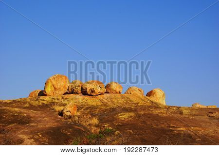 red rocks and big stones in Matopos-Rhodes National Park in Zimbabwe under an empty blues sky