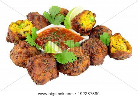 Group of fried vegetable pakora with chilli sauce dip isolated on a white background